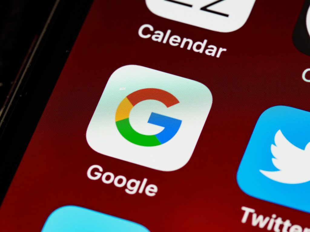 IGoogle Pixel 9a: The Ultimate Mid-Range Smartphone with High-End amazing Features 1 Macro view of a smartphone displaying Google and other app icons on the home screen.