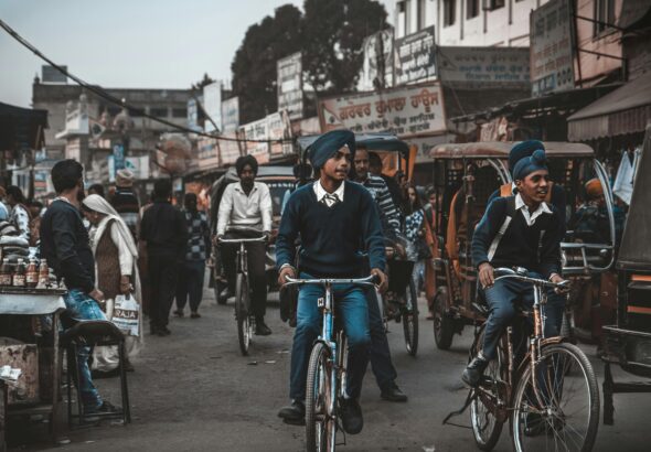 Street life in Amritsar with boys on bicycles and vibrant market activity. punjab board pseb 10th result 2025