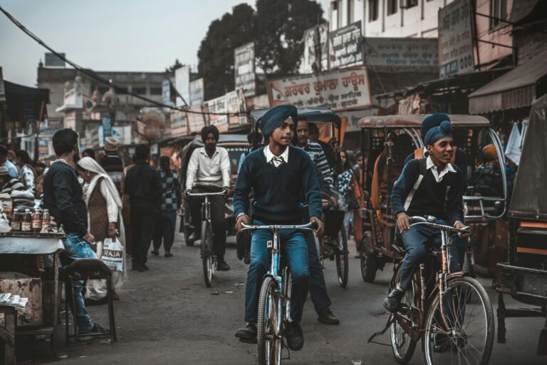 Street life in Amritsar with boys on bicycles and vibrant market activity. punjab board pseb 10th result 2025