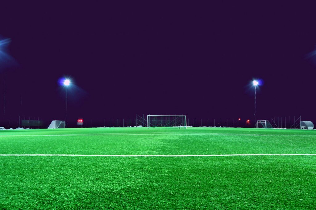 A brightly lit soccer field at night in Norrtälje, Sweden, showcasing green turf and stadium lights. Scotland vs Netherlands