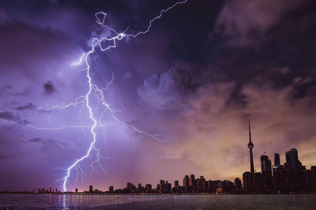 WEATHER 1 A striking lightning bolt illuminates the Toronto skyline against a dramatic stormy sky. WEATHER TODAY