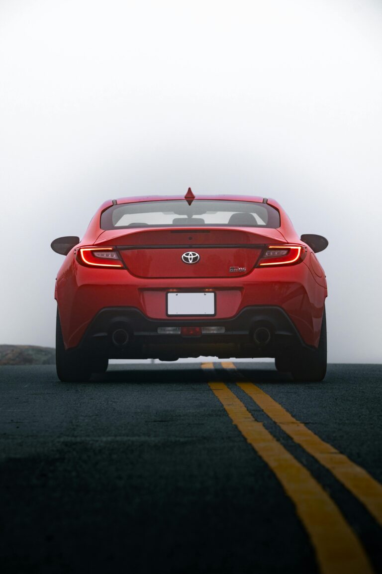 Rear view of a Toyota camry GR86 on an open road, showcasing sporty design and modern aesthetics.