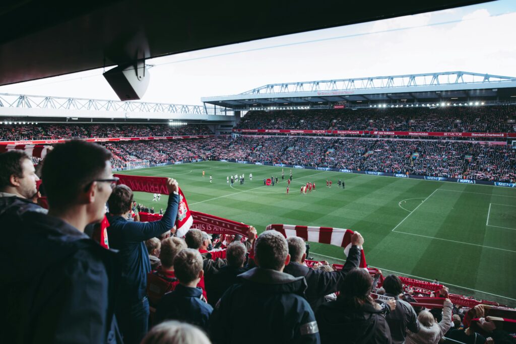 Fans cheer as players take the field at a vibrant football stadium, creating an electric atmosphere. inter miami