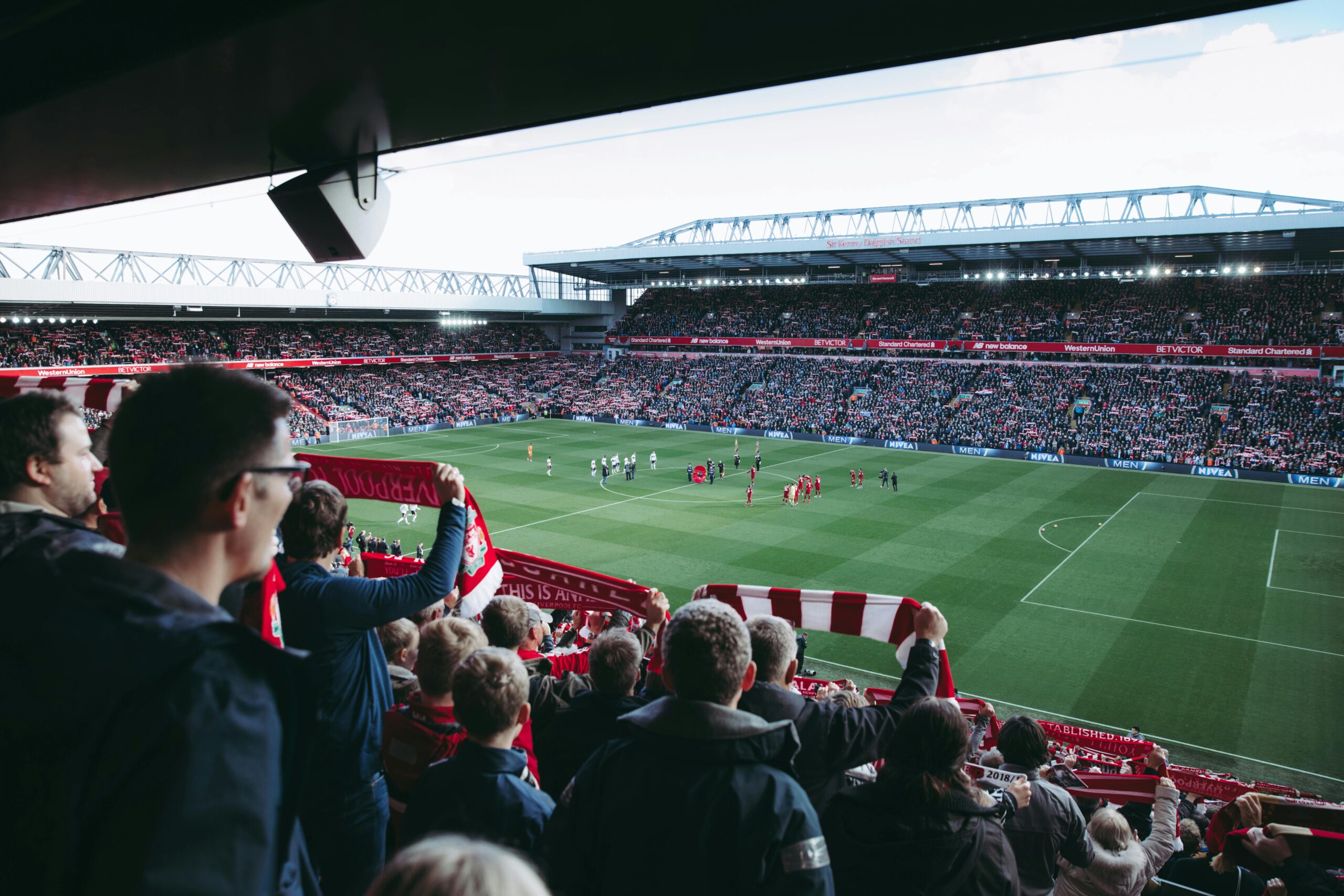 Fans cheer as players take the field at a vibrant football stadium, creating an electric atmosphere. inter miami