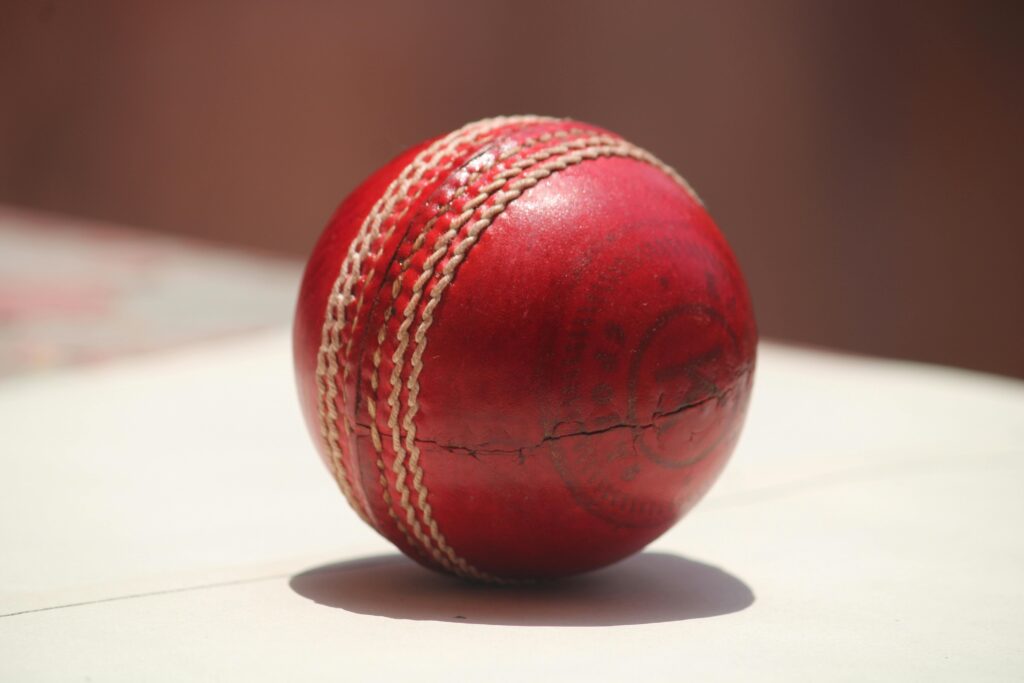 punjab kings vs royal challengers bengaluru match scorecard 1 Detailed close-up of a red leather cricket ball showing wear and stitching. punjab kings vs royal challengers bengaluru match scorecard