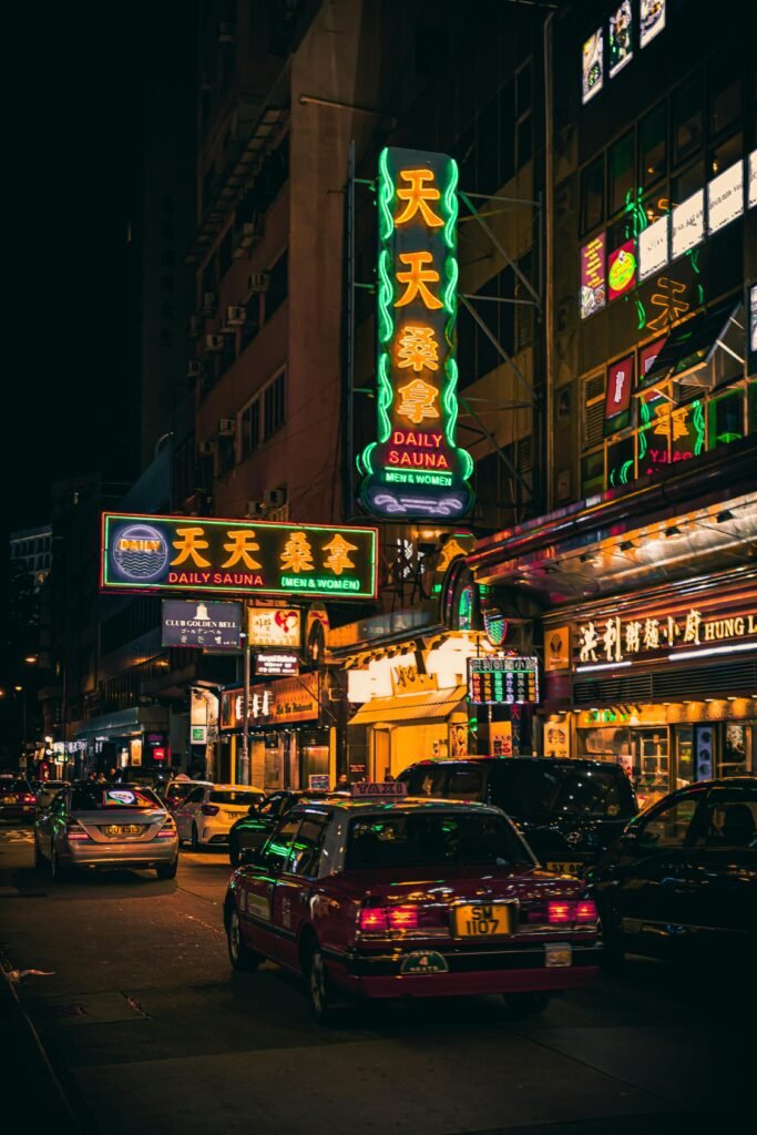 Exploring the vibrant nightlife of Hong Kong with neon signs illuminating the busy streets. China Strengthens