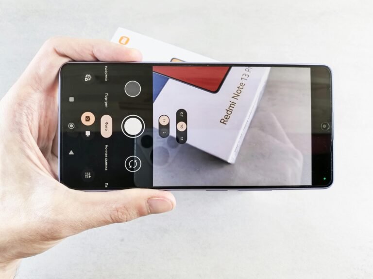 Close-up of a smartphone camera app focusing on a Redmi Note 13 Pro box. Redmi 15 Mobile
